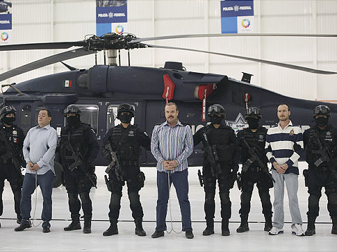 Federal officers escort accused drug trafficker and two other alleged drug cartel members in Mexico City in November.